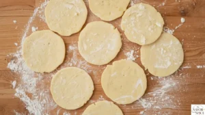 Rolling out pizza dough into circles for Chicken Bacon Ranch Calzones.