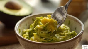 Mashed avocados to make avocado toast with poached eggs.
