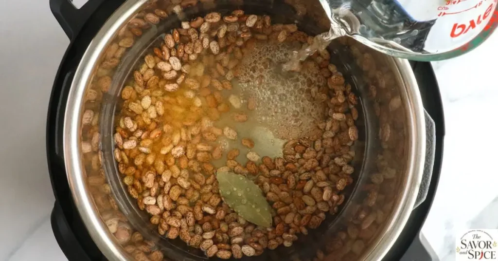Add beans, liquid, and seasonings to the Instant Pot.
